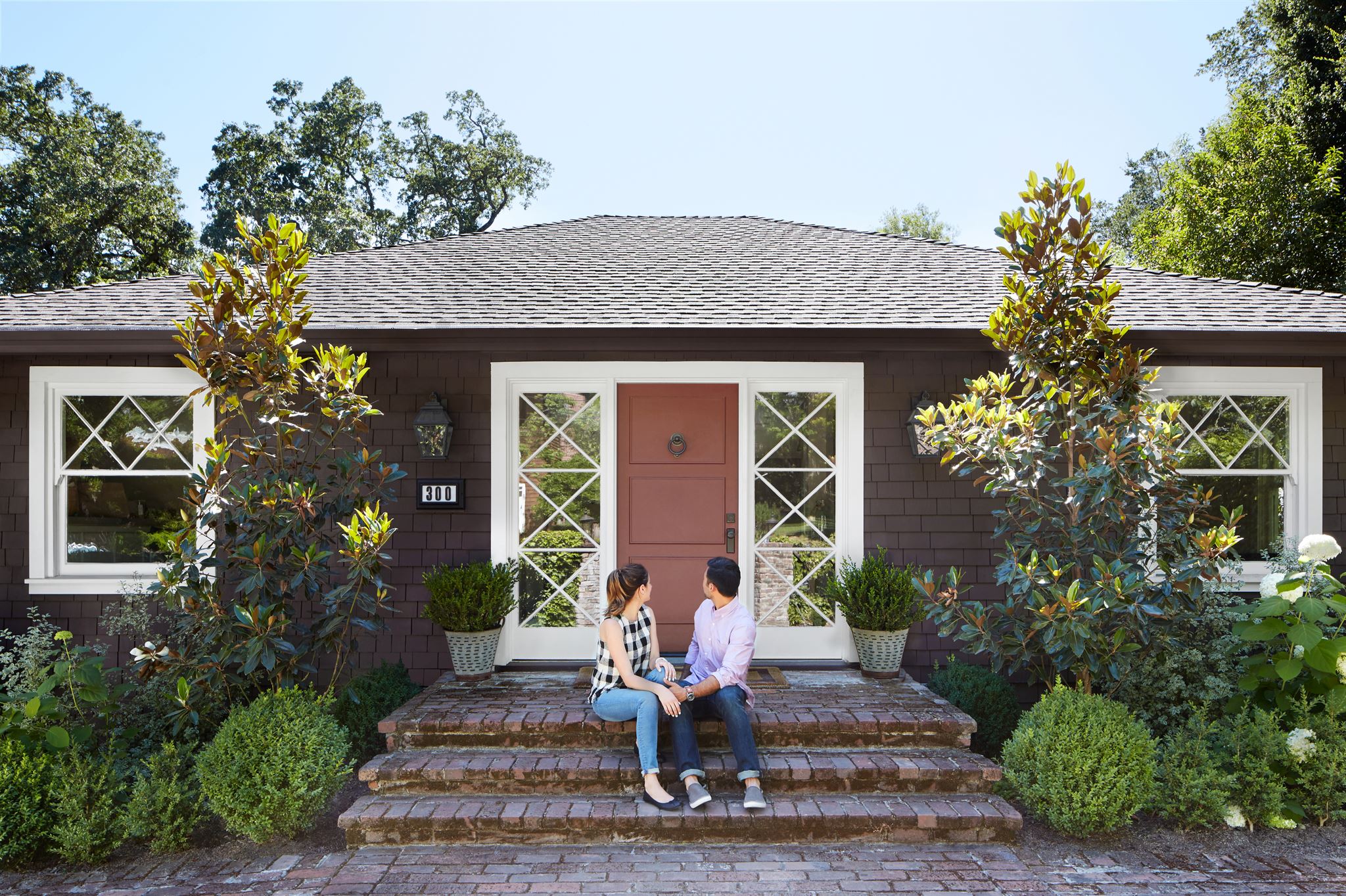 Couple-sitting-in-front-of-house